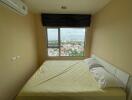 Bedroom with large window and city view