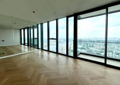 Spacious living area with floor-to-ceiling windows and city view