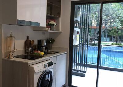 Modern kitchen with built-in appliances and pool view