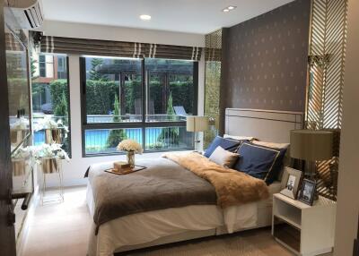 Modern bedroom with large windows overlooking a pool