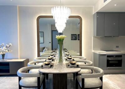 Modern dining area with chandelier and table set