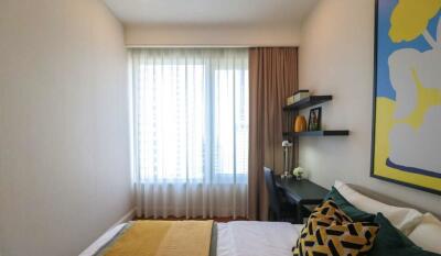 Modern bedroom with window, desk, and wall art