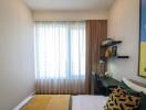 Modern bedroom with window, desk, and wall art