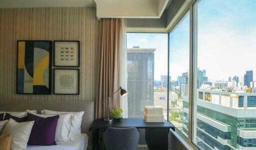 Modern bedroom with large windows and city view