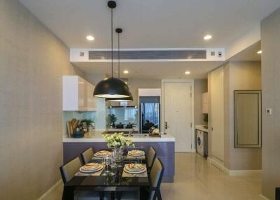 Modern dining area with kitchen in the background