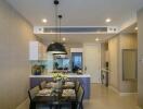 Modern dining area with kitchen in the background