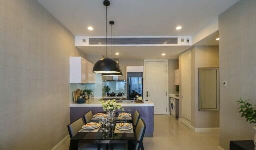 Modern dining area with kitchen in the background