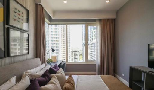 Modern bedroom with a large window and city view