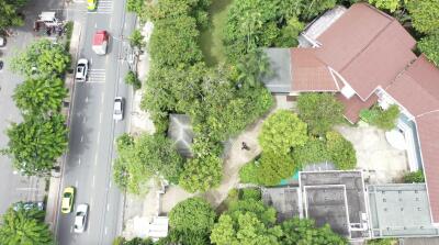 Aerial view of the property highlighting surrounding greenery and buildings