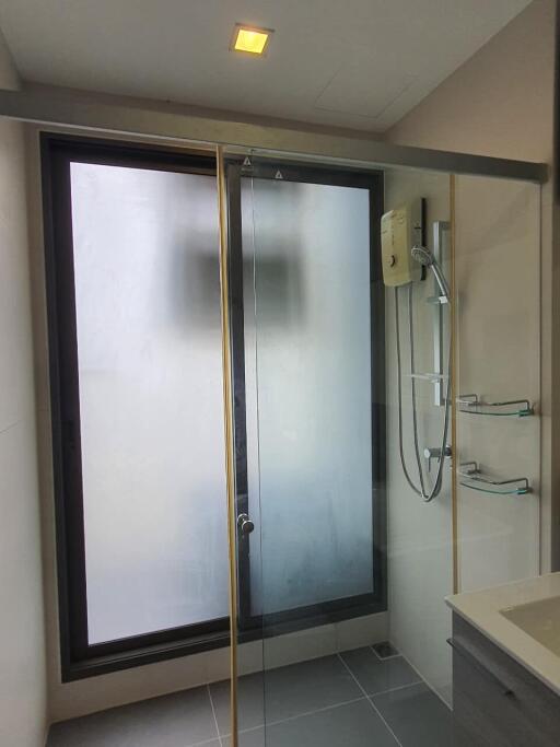 Modern bathroom with glass shower enclosure and large window