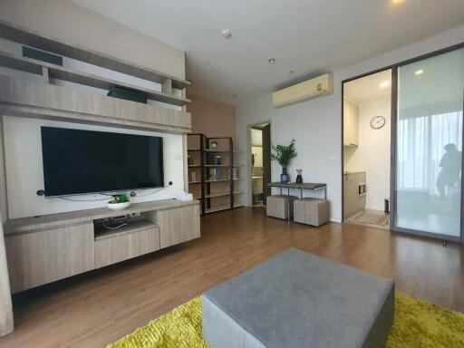 Modern living room with wooden flooring and built-in shelving