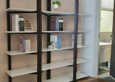 Bookshelves in the study with a view into an adjacent room