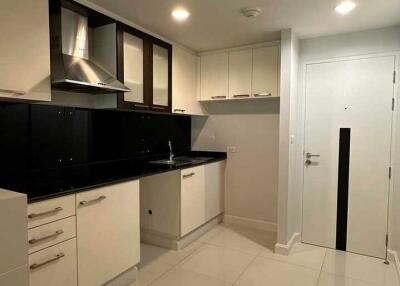 Modern kitchen with white cabinets and black countertops