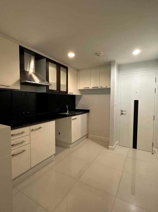 Modern kitchen with white cabinets and black countertops