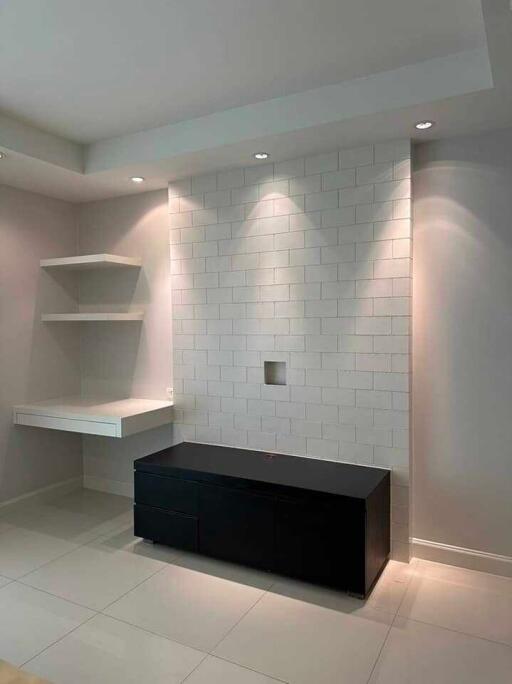 Modern living room with wall-mounted shelves and under-cabinet lighting