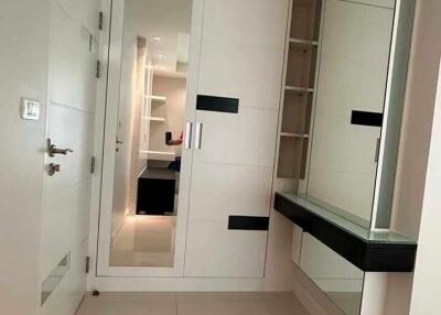 Modern hallway with storage and a large mirror