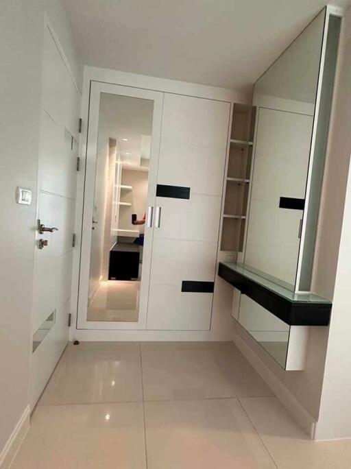 Modern hallway with storage and a large mirror