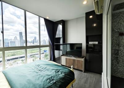 Modern bedroom with large windows and city view