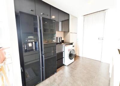 Modern kitchen with black appliances and a washer