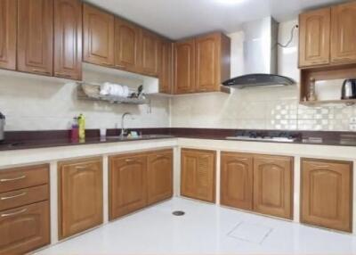 Modern kitchen with wooden cabinets and appliances