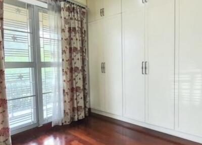 Bedroom with large windows and built-in wardrobes