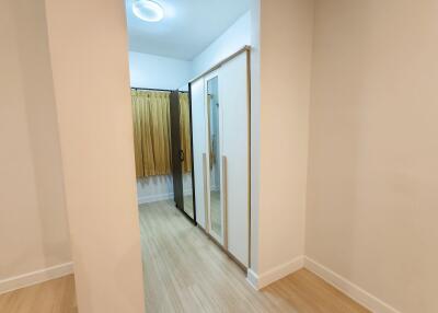 well-lit bedroom with a wardrobe and wooden flooring