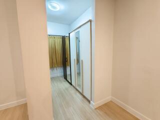 well-lit bedroom with a wardrobe and wooden flooring