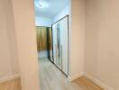 well-lit bedroom with a wardrobe and wooden flooring