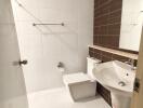 Modern white-tiled bathroom with brown accent wall