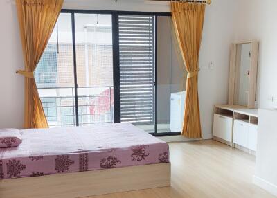 Spacious bedroom with large window and balcony access