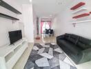 Modern living room with black sofa and wall-mounted shelves