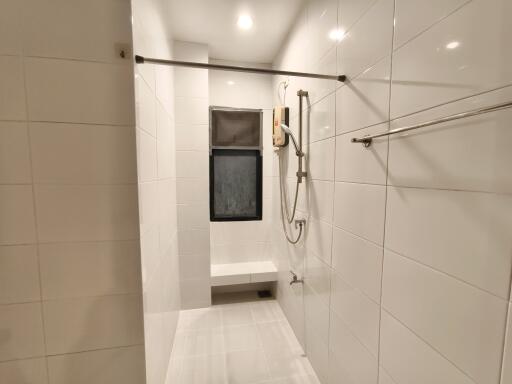 Modern bathroom with shower area and white tiles