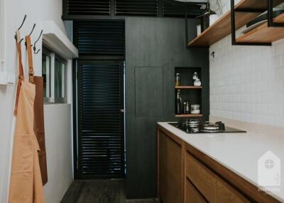 Modern kitchen with wooden cabinets and black finishes