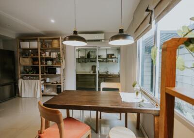 Cozy dining area with natural lighting and view into the kitchen