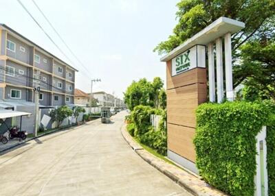 Exterior view of residential buildings with street and greenery