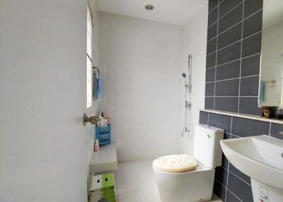 Modern bathroom with shower area, toilet, and sink