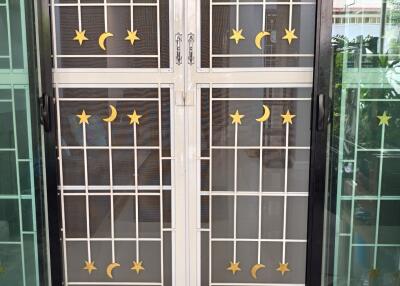 Entrance door with decorative security grill