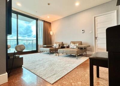 Modern living room with large windows and comfortable seating