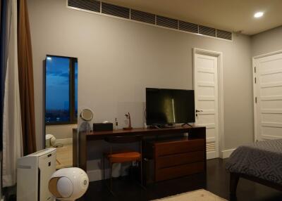 Modern bedroom with desk and television