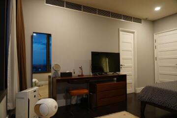 Modern bedroom with desk and television