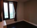 Bedroom with large window and wooden floor