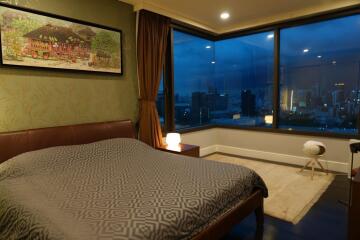 Bedroom with large window and city view