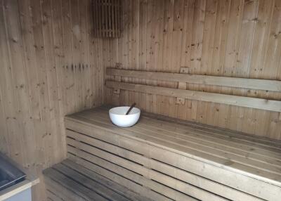 Wooden sauna with a bowl and ladle