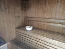 Wooden sauna with a bowl and ladle