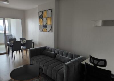 modern living room with grey sofa and adjoining dining area