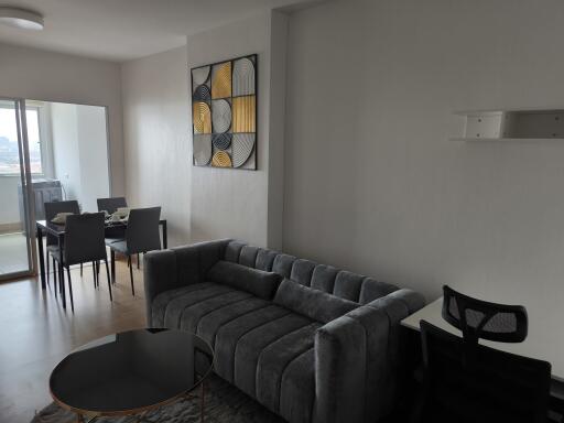 modern living room with grey sofa and adjoining dining area