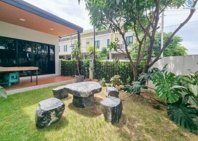 Outdoor garden area with stone table and seats