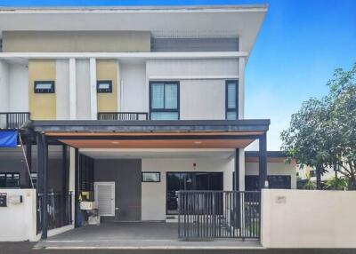 Modern two-story house with a carport and balcony