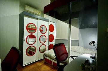 Modern bedroom with bunk bed and circular design elements