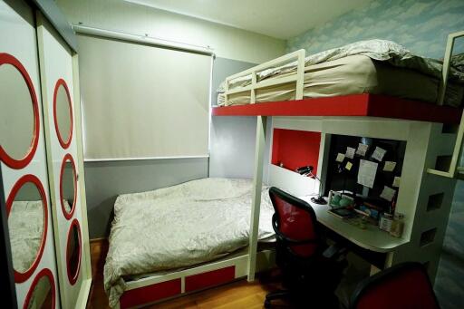 Modern bedroom with bunk beds, desk, and wardrobe